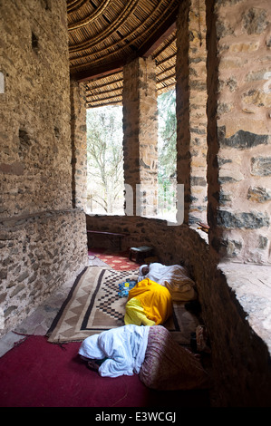 Orthodox women praying the Ethiopian way ( i.e. by lying on the ground) in a church ( Ethiopia) Stock Photo