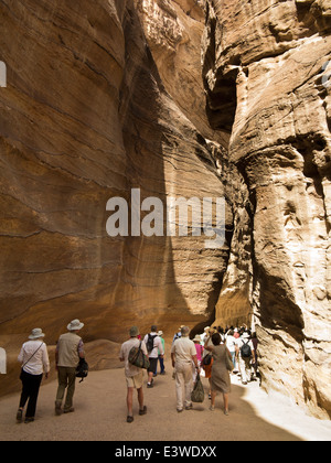 Jordan, Arabah, Petra, tourists walking through Al-Siq entrance canyon to site