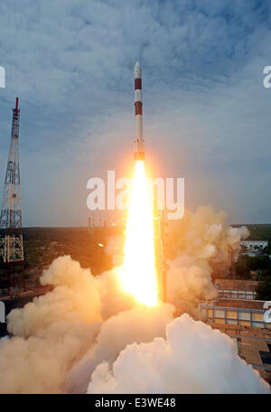 Sriharikota, India. 30th June, 2014. The Polar Satellite Launch Vehicle C-23 rocket lifts off from the east coast island of Sriharikota, India, June 30, 2014. Indian Space Research Organisation (ISRO) on Monday successfully launched the Polar Satellite Launch Vehicle C-23 rocket at 9:52 a.m. local time with five foreign satellites from Satish Dhawan Space Centre in Sriharikota of south Indian state of Andhra Pradesh. Credit:  Stringer/Xinhua/Alamy Live News Stock Photo