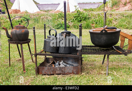 camping cooking on campfire with old iron pots Stock Photo - Alamy