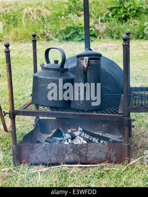 cooking on campfire with old iron pots Stock Photo