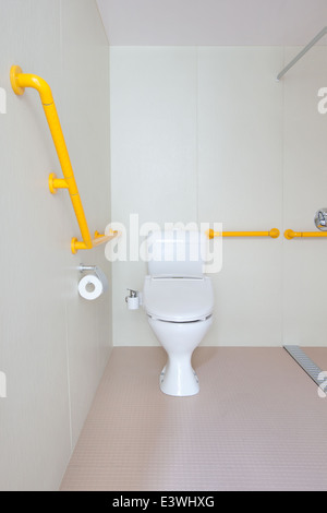 disabled clean compact modern bathroom new commercial. including - mirror, shower, sink, toilet, tiles, cubical, storage. Stock Photo