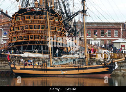 AJAXNETPHOTO. 2005. PORTSMOUTH, ENGLAND - REPLICA OF THE 18TH CENT. SCHOONER PICKLE COMMANDED BY LT.JOHN LAPENOTIERE WHO BROGHT THE GOOD AND THE BAD NEWS OF THE BATTLE OF TRAFALGAR TO BRITAIN IN 1805 AFTER A NINE DAY PASSAGE FROM THE STRAITS OF GIBRALTAR. THE REPLICA WAS BUILT IN RUSSIA IN 1996. IN THE BACKGROUND, NELSON'S FLAGSHIP HMS VICTORY. PHOTO:JONATHAN EASTLAND REF:D50307/2/214 Stock Photo