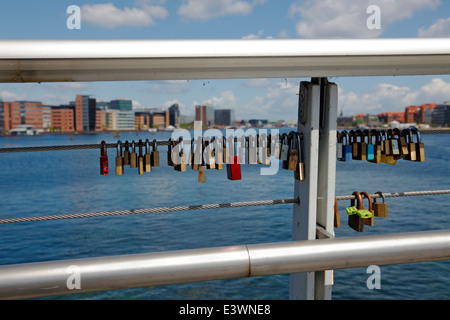 Love locks on the combined bicycle and walkway steel bridge, Bryggebroen, over the southern part of the port of Copenhagen. Denmark. Stock Photo