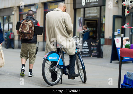 Cardiff, UK. 30th June 2014. The cast of BBC Doctor Who are spotted filming in Cardiff city centre. The Doctor (Peter Capaldi) was seen standing off against the Cybermen with UNIT soldiers and actress Michelle Gomez. Photo shows a 'Boris bike', one of the props used to turn the Cardiff street into London. Credit:  Polly Thomas/Alamy Live News Stock Photo