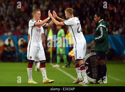 Porto Alegre, Brazil. 30th June, 2014. Germany's Bastian Schweinsteiger (L) is replaced by Christoph Kramer (C) during a Round of 16 match between Germany and Algeria of 2014 FIFA World Cup at the Estadio Beira-Rio Stadium in Porto Alegre, Brazil, on June 30, 2014. Germany won 2-1 over Algeria after 120 minutes and qualified for quarter-finals on Monday. Credit:  Li Ga/Xinhua/Alamy Live News Stock Photo