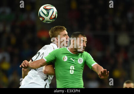 Porto Alegre, Brazil. 30th June, 2014. Algeria's Medhi Lacen (R) vies with Germany's Christoph Kramer during a Round of 16 match between Germany and Algeria of 2014 FIFA World Cup at the Estadio Beira-Rio Stadium in Porto Alegre, Brazil, on June 30, 2014. Germany won 2-1 over Algeria after 120 minutes and qualified for quarter-finals on Monday. Credit:  Li Ga/Xinhua/Alamy Live News Stock Photo