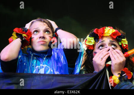 Berlin, Germany. 1st July, 2014. German football fans react as they watch the 2014 World Cup round of 16 soccer match between Germany and Algeria at a public viewing event in Berlin, June 30, 2014. © Xinhua/Alamy Live News Stock Photo