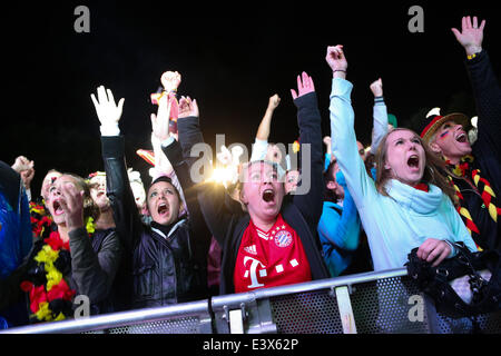 Berlin, Germany. 1st July, 2014. German football fans celebrate as they watch the 2014 World Cup round of 16 soccer match between Germany and Algeria at a public viewing event in Berlin, June 30, 2014. © Xinhua/Alamy Live News Stock Photo