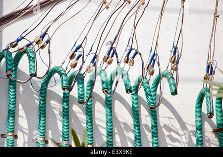 electricity cable wire on house wall in asia, India Stock Photo