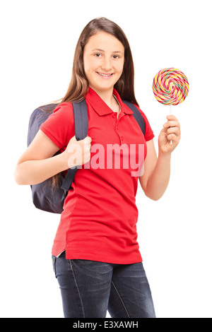 Teenage schoolgirl holding a colorful lollipop Stock Photo