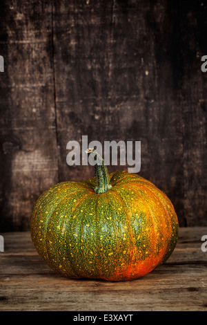 Pumpkin on old wooden table Stock Photo