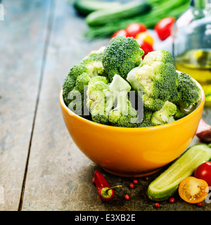 Fresh green broccoli and Healthy Organic Vegetables on a Wooden Background. Stock Photo