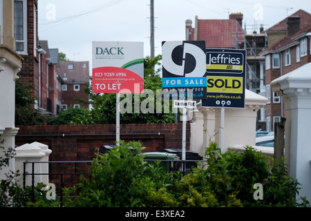 estate agents boards outside residential apartments in an urban city center Stock Photo