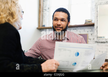 Businesswoman talking to young businessman Stock Photo