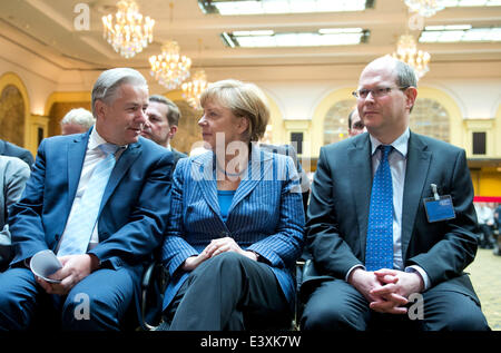 Berlin, Germany. 1st July, 2014. German Chancellor Angela Merkel (C), mayor of Berlin Klaus Wowereit (L) and director of the German Resistance Memorial Center Johannes Tuchel attend the official inauguration of the newly designed permanent exhibition at the German Resistance Memorial Center in Berlin, Germany, 01 July 2014. The new permamnent exhibition 'Resistance against National Socialism' is housed in a part of the Bendlerblock, the headquarters of a  resistance group of Wehrmacht officers who carried out the 20 July plot against Adolf Hitler in 1944. Credit:  dpa picture alliance/Alamy Li Stock Photo