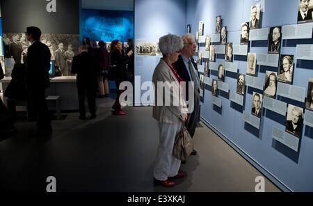 Berlin, Germany. 1st July, 2014. Visitors walk through the newly designed permanent exhibition at the German Resistance Memorial Center in Berlin, Germany, 01 July 2014. The new permamnent exhibition 'Resistance against National Socialism' is housed in a part of the Bendlerblock, the headquarters of a resistance group of Wehrmacht officers who carried out the 20 July plot against Adolf Hitler in 1944, and portrays the diversity of the German resistance during the Third Reich. Photo: BERND VON JUTRCZENKA/DPA/Alamy Live News Stock Photo