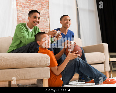 Mixed race brothers playing video games together Stock Photo