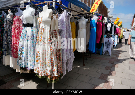 A market stall selling a selection of clothes dresses & cardigans in Worthing precinct pedestrianised area West Sussex UK Stock Photo