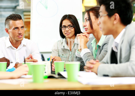 Business people having meeting around table in office Stock Photo