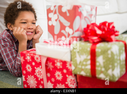 Black boy admiring Christmas presents Stock Photo