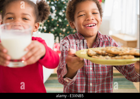 Black children with milk and cookies for Santa Claus Stock Photo