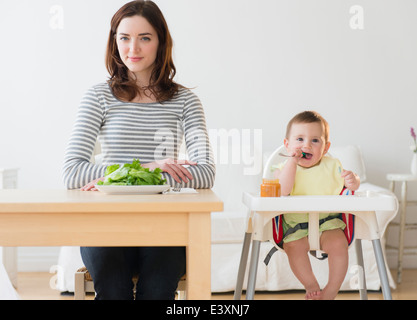 Mother and baby eating together Stock Photo
