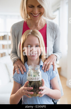 Senior Caucasian woman and granddaughter saving for college Stock Photo
