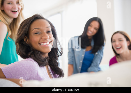 Smiling woman sitting with friends Stock Photo