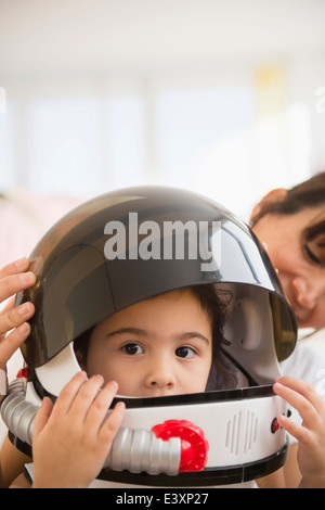 Hispanic mother and daughter playing dress up Stock Photo