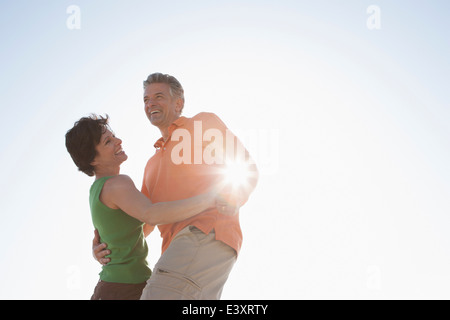 Caucasian couple dancing outdoors Stock Photo