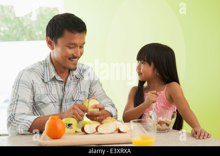 Asian father and daughter having breakfast together Stock Photo