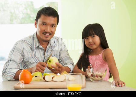 Asian father and daughter having breakfast together Stock Photo