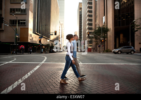 Couple crossing city street Stock Photo