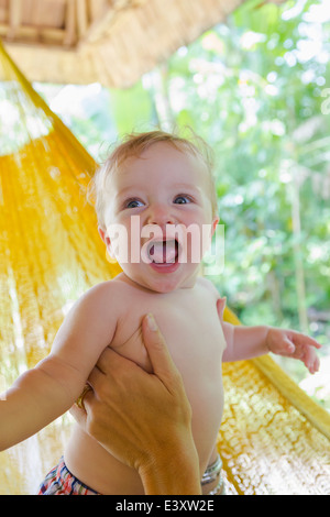 Caucasian mother holding baby in hammock Stock Photo