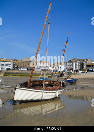 Wooden sailing boat moored in the harbour of the fishing village of St Ives in Cornwall, UK at low tide. Stock Photo