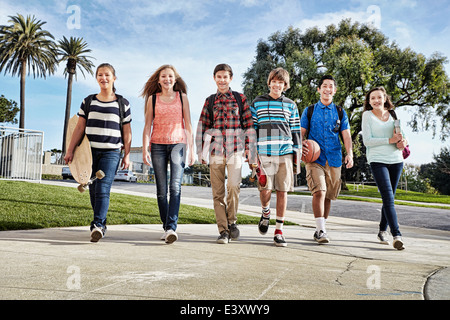 Teenagers walking to school Stock Photo