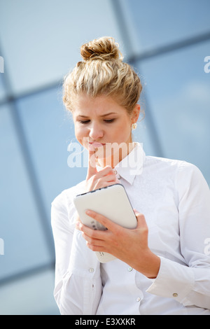 Businesswoman using tablet computer in the city Stock Photo
