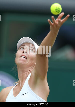 Wimbledon, London, UK. 1st July, 2014. Russia's Maria Sharapova serves during the women's singles fourth round match against Germany's Angelique Kerber at the 2014 Wimbledon Championships in Wimbledon, southwest London, July 1, 2014. Sharapova lost the match 1-2. Credit:  Meng Yongmin/Xinhua/Alamy Live News Stock Photo