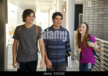 College students laughing in corridor Stock Photo
