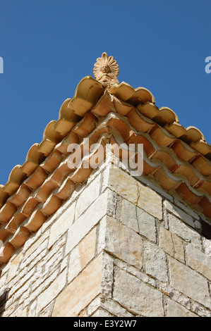 Ceramic antefix decorative pottery ornament on the roof of a house in Greece. Architectural detail. Stock Photo