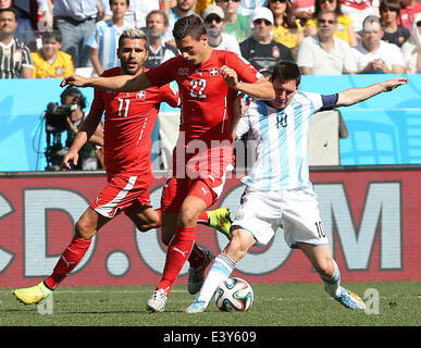Sao Paulo, Brazil. 1st July, 2014. Argentina's Lionel Messi vies with Switzerland's Fabian Schaer (C) during a Round of 16 match between Argentina and Switzerland of 2014 FIFA World Cup at the Arena de Sao Paulo Stadium in Sao Paulo, Brazil, on July 1, 2014. Credit:  Xu Zijian/Xinhua/Alamy Live News Stock Photo