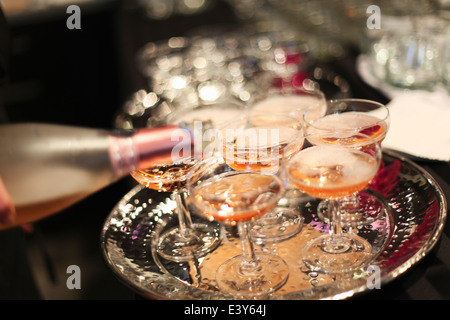 Pouring wine into glasses Stock Photo