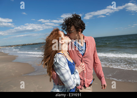 Romantic couple kissing on beach Stock Photo