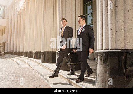 Two business lawyers with briefcase leaving courthouse Stock Photo