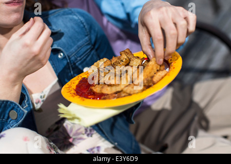 Cropped close up of couple eating chips Stock Photo