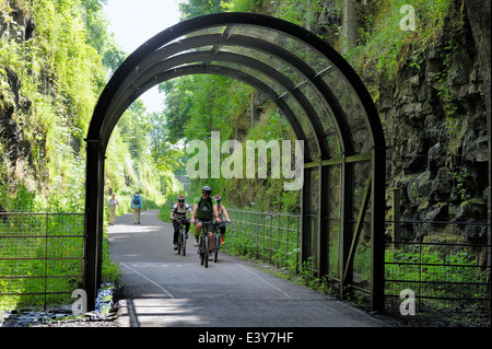Cyclists entering headstone tunnel on the Monsal trail Derbyshire England UK Stock Photo