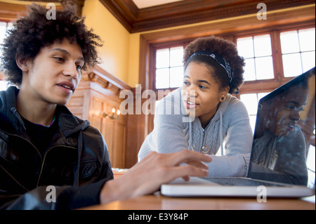 African college students using laptop together isolated on white ...