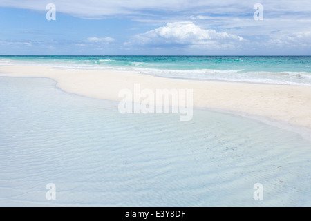 Peaceful emptiness on the white sand beach of Tulum, Mexico, the azure Carabbean in the distance. Stock Photo