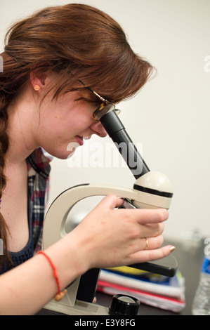 Science student using microscope Stock Photo